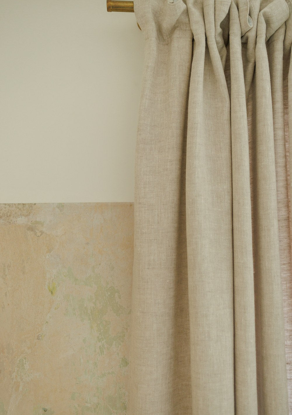 Extra long linen curtain panel – heading tape gathered on a brass rod