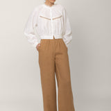 White victorian blouse Flore in linen styled with camel wide leg trousers